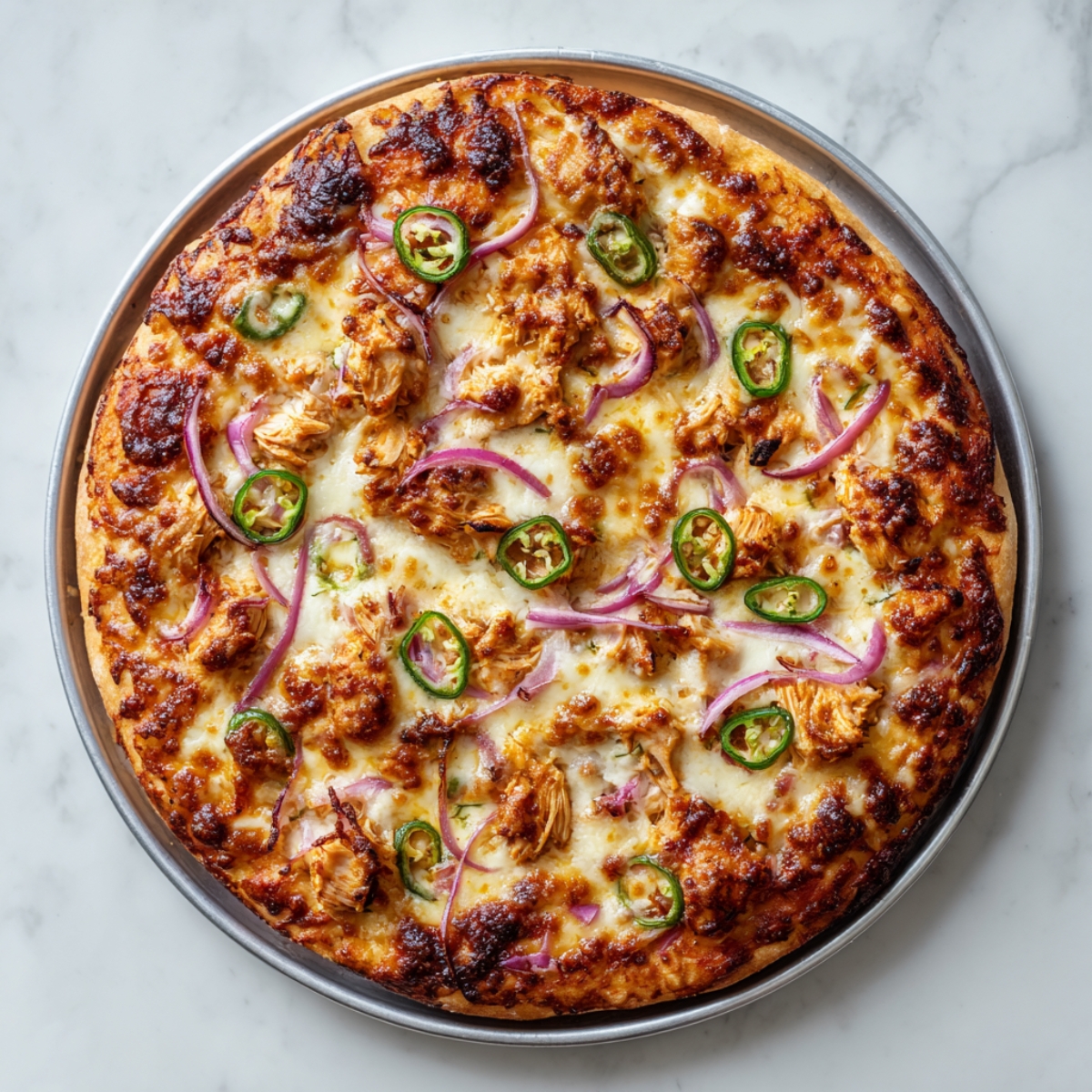 Pizza BBQ chicken mtbou5a b cheddar w mozzarella mghatta b jalapeño w bassla 7amra 3la ta9rira mtboukha.