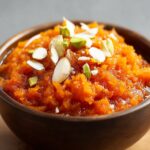 A delicious Indian Carrot Halwa Recipe made from grated carrots cooked in ghee, milk, and sugar, garnished with nuts.