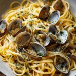 Clam Linguine Recipe: A delicious and simple pasta dish featuring tender linguine tossed with fresh clams, garlic, olive oil, and a hint of white wine, garnished with a sprinkle of parsley and a touch of grated Parmesan cheese.