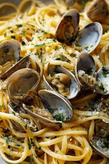 Clam Linguine Recipe: A delicious and simple pasta dish featuring tender linguine tossed with fresh clams, garlic, olive oil, and a hint of white wine, garnished with a sprinkle of parsley and a touch of grated Parmesan cheese.