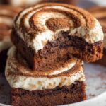 Tiramisu cookies with mascarpone cream swirls and cocoa dusting served on a white plate.