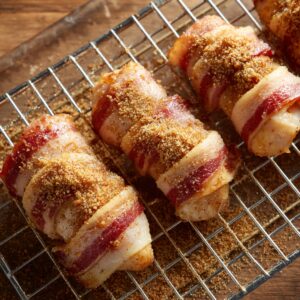 Bacon-wrapped chicken with sugar coating: Chicken tenders wrapped in bacon and sprinkled generously with brown sugar, ready to bake.