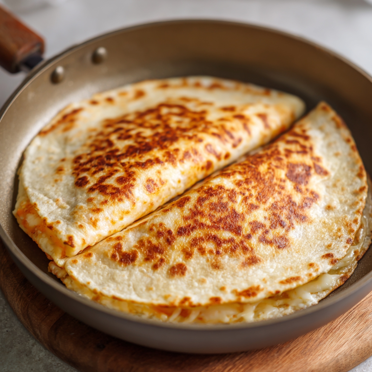 Crispy quesadillas folded in half and pan-fried, with melted cheese oozing from the edges.