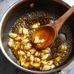 Heat olive oil in a large pot and sauté the garlic. Start by warming olive oil in a large pot or pan. Once the oil is hot, add garlic and sauté it until it becomes fragrant and golden. The garlic will infuse the oil, creating a rich base for the pasta sauce that will coat the linguine and clams.