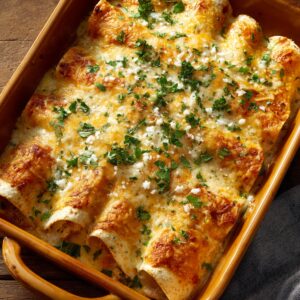 Best Creamy White Chicken Enchiladas Recipe 23 This image shows the final baked enchiladas — no visible text present.
