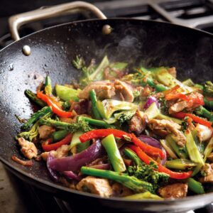 A large skillet or wok heating on high, with oil starting to smoke for stir-frying.