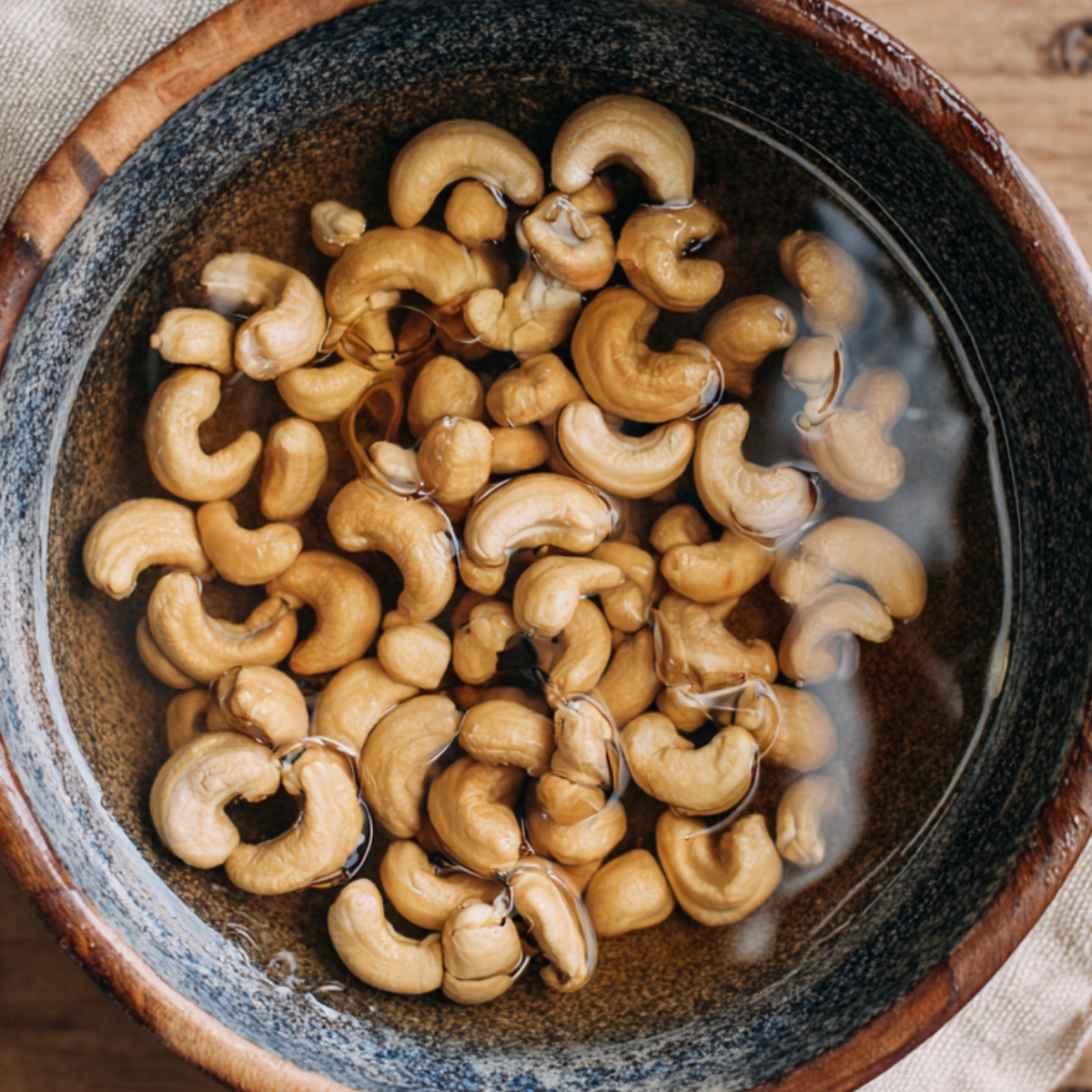 Soaked cashews placed in a bowl, ready for blending or adding to a recipe.