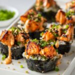 Baked Salmon Sushi Cups Crispy baked salmon sushi cups on a white plate, nori seaweed cups filled with rice and roasted salmon, topped with spicy mayo and green onions