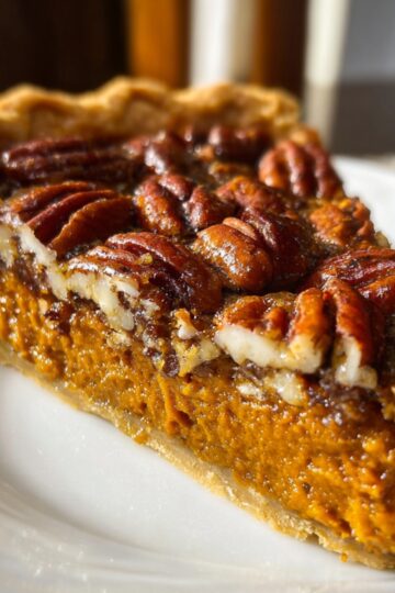 Healthy Sweet Potato Pecan Pie Recipe 24 Sweet Potato Pecan Pie Slice of sweet potato pecan pie on a plate highlighting the two distinct layers and glossy pecan topping, with the full pie in the background.