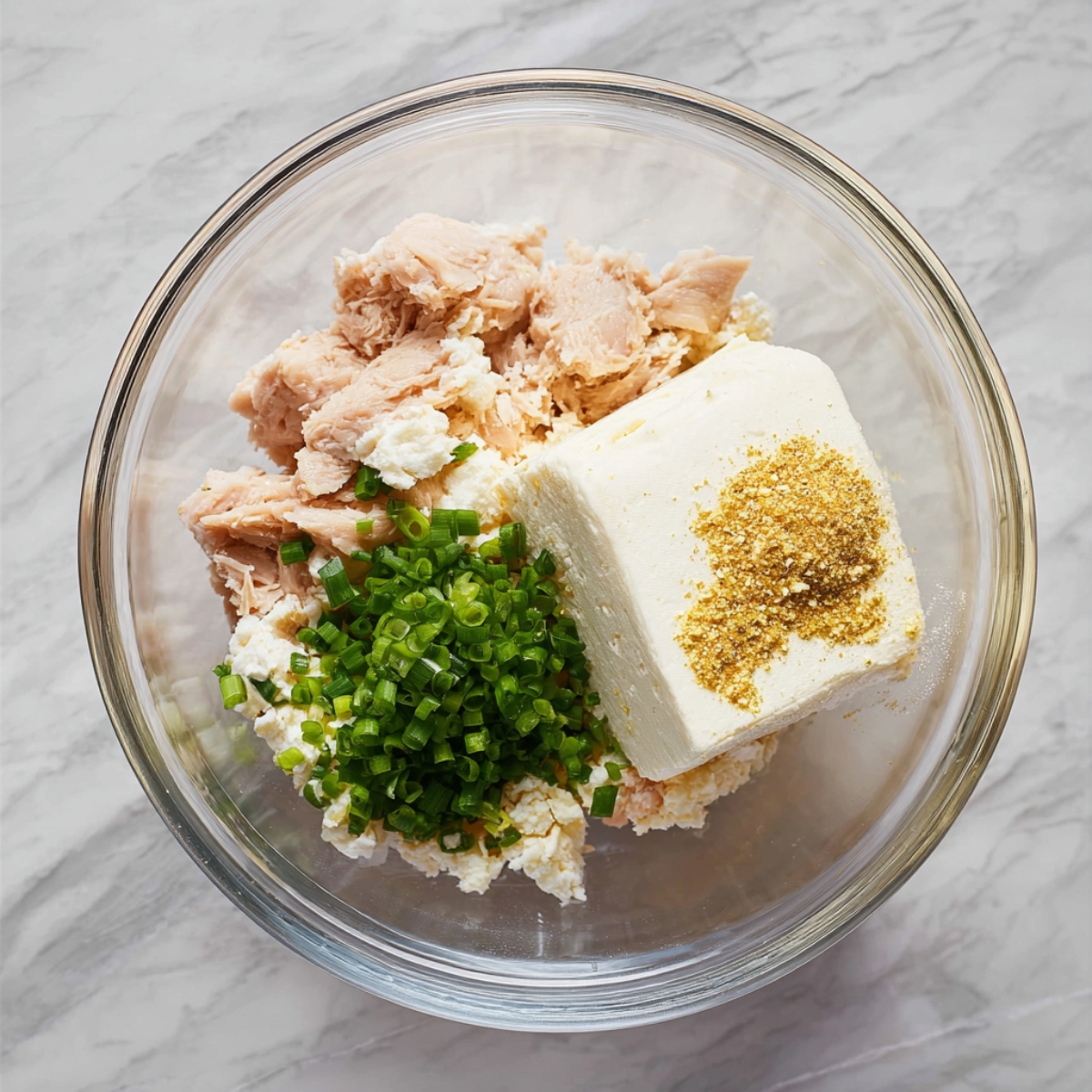 Healthy Chicken Pillows Recipe | Ready in 30 Minutes 10 Mixing bowl filled with shredded chicken, cream cheese, green onions, and seasoning before stirring.