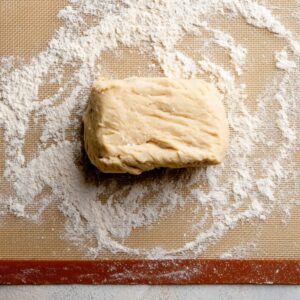 Delicious Cinnamon Roll Cookies Recipe 15 Block of cookie dough resting on a floured silicone baking mat