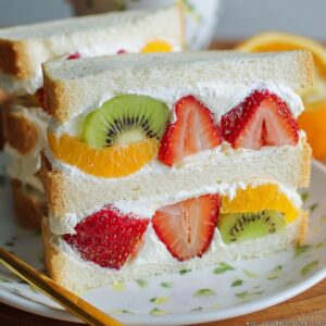 Japanese Fruit Sandwich Recipe (Ready in 10 Minutes!) 18 "A delicious fruit sandwich filled with fresh strawberries, kiwi, and orange slices, layered with smooth whipped cream, perfect for a light snack."