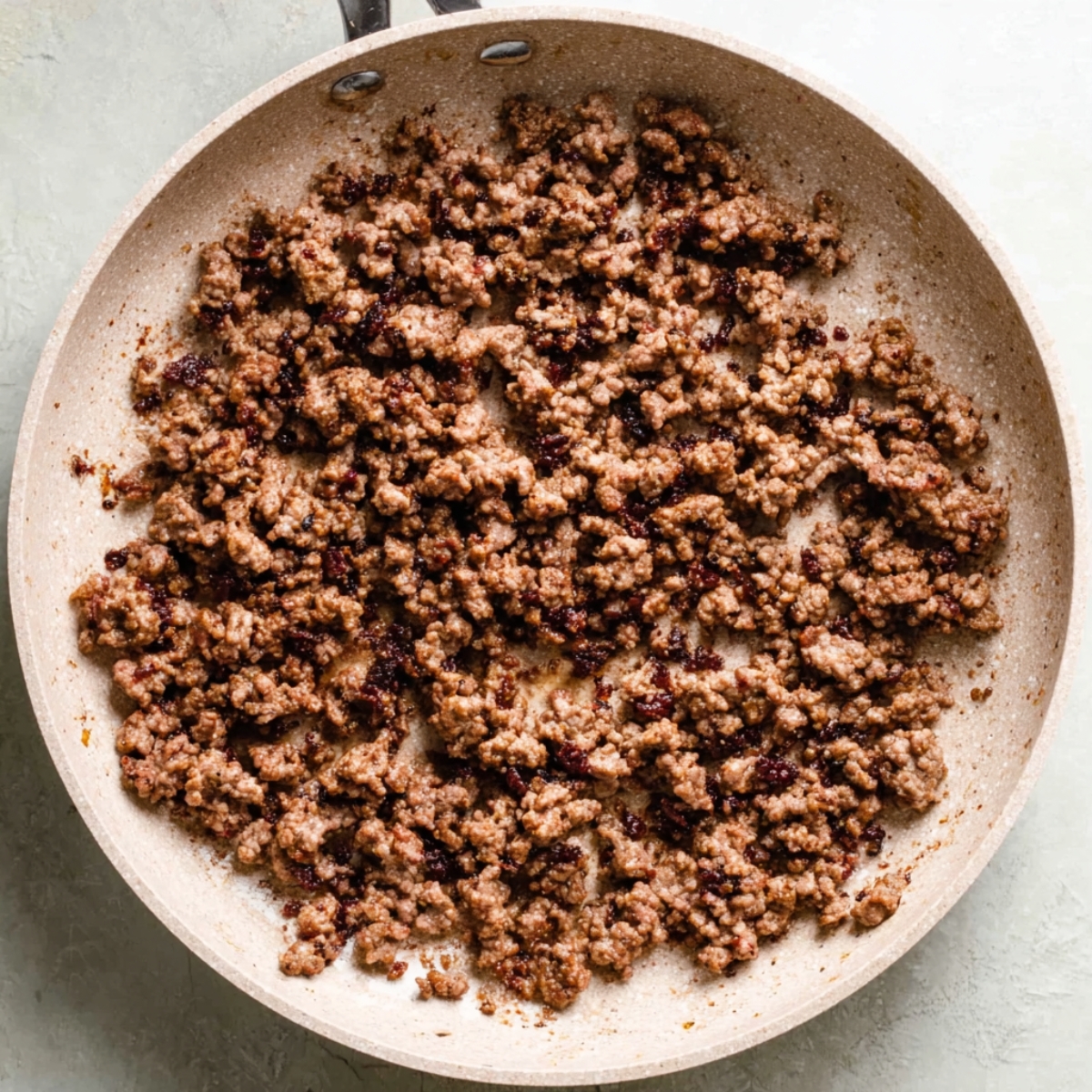 Easy Korean Ground Beef Bowl Recipe | 20-Minute Dinner 10 Fully cooked ground beef spread evenly in a skillet, browned and caramelized.