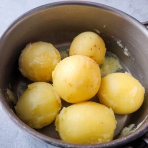 The Best Scottish Tattie Scones Recipe (Just 3 Ingredients!) 16 A close-up of peeled and boiled potatoes in a pot, ready to be mashed for making Scottish tattie scones.