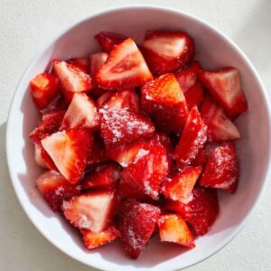 Best Strawberry Danishes | 5 Ingredients & Flaky 15 “Bowl of chopped fresh strawberries mixed with sugar, showing a glossy red texture.”