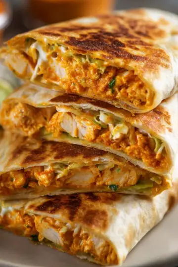 Chicken Crunch Wrap Recipe - Crispy & Ready in 30 Min 7 Chicken Crunch Wrap Professional food photography of sliced crispy chicken crunchwraps stacked on a plate, golden toasted tortilla, creamy orange chicken filling visible, dipping sauce on the side, shallow depth of field, restaurant-style presentation, ultra realistic
