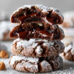 Nutella crinkle cookies Homemade Nutella crinkle cookies stacked with cracked powdered sugar exterior and gooey chocolate filling