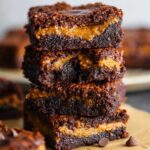 Pumpkin Brownies Recipe A stack of pumpkin brownies, showing the gooey, pumpkin-infused center between layers of rich chocolate, ready to be enjoyed.