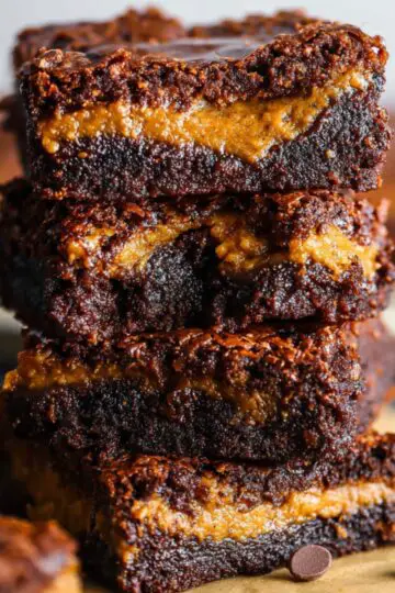 Delicious Pumpkin Brownies Recipe 11 Pumpkin Brownies Recipe A stack of pumpkin brownies, showing the gooey, pumpkin-infused center between layers of rich chocolate, ready to be enjoyed.