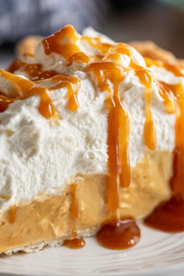 Easy Butterscotch Pie Recipe | 9 Steps to Silky Perfection 2 butterscotch pie Slice of butterscotch cream pie with a flaky crust, creamy caramel filling, and whipped cream topping drizzled with sauce.