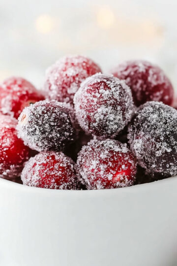 Sugared Cranberries Recipe | 3-Ingredient Easy Guide 21 sugared cranberries A white bowl filled with sugar-coated cranberries, styled on a bright, soft background.
