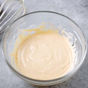 Easy Chocolate Mayonnaise Cake | 45-Minute Recipe 15 A bowl of creamy, smooth frosting, ready to be applied to a cake or dessert.