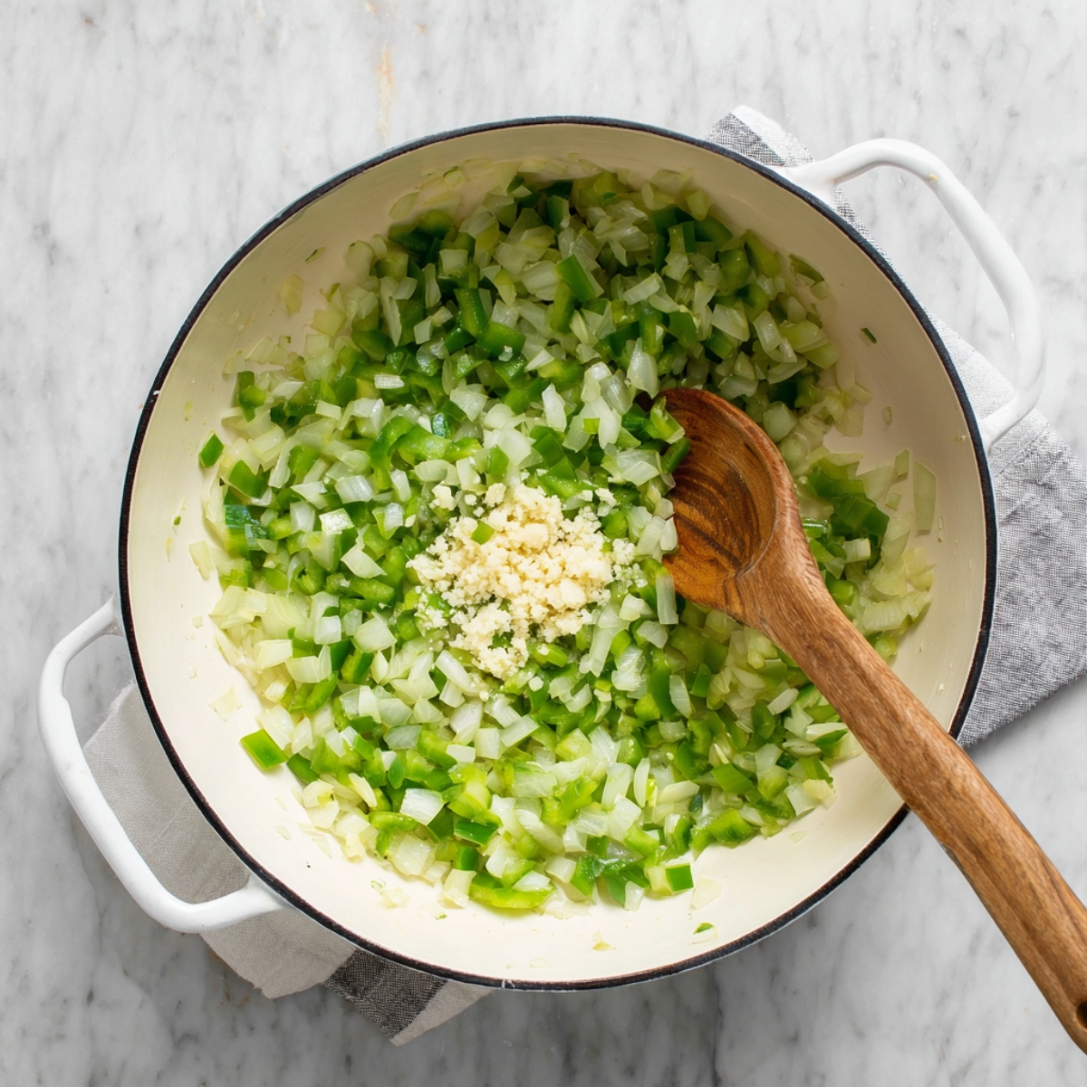 One-Pan Taco Spaghetti Recipe | Ready in 30 Minutes 10 Diced onions and green bell peppers sautéing in a pot with minced garlic added.