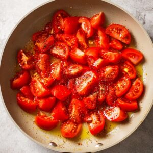 Easy Creamy Tomato Gnocchi with Burrata Recipe 14 Fresh tomatoes cut in half and placed in a pan, beginning to soften in the cooking oil.
