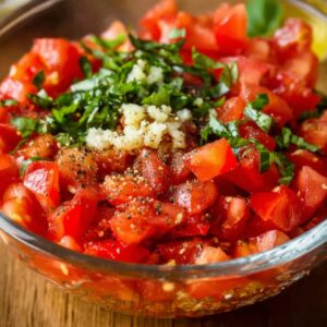 Easy Tomato Bruschetta Recipe | Ready in 37 Minutes 16 Glass bowl of diced tomatoes mixed with garlic, basil, olive oil, salt, and black pepper
