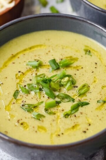 The Best Asparagus Soup Recipe 1 Asparagus Soup A creamy and vibrant bowl of asparagus soup, garnished with freshly chopped green onions and a drizzle of olive oil, offering a smooth and rich texture, perfect for a comforting meal.