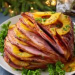Baked Ham A beautifully sliced baked ham with pineapple slices arranged between the layers, garnished with parsley.