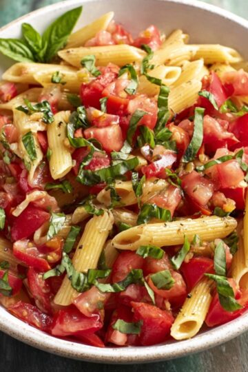 The Best Bruschetta Pasta Recipe 2 Bruschetta Pasta Create a recipe for a vibrant summer pasta salad with fresh tomatoes and basil. Describe how to toss cooked penne pasta with diced tomatoes, fresh basil, and a light vinaigrette or olive oil dressing. Offer tips on seasoning and suggest optional additions, like mozzarella or red onions, to enhance the dish's flavor.