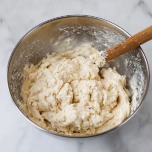 Healthy Chicken and Dumplings with Biscuits 15 A close-up of soft, sticky dumpling dough mixed and ready to be dropped into a pot of simmering turkey broth. The dough is thick and slightly lumpy, perfect for creating the light and fluffy dumplings in the dish