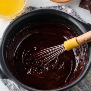 Easy Cosmic Brownies Recipe 18 Melted chocolate and butter being whisked together in a bowl.