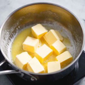 Easy Hollandaise Sauce Recipe 15 Cubes of butter in a saucepan, ready to be melted for making hollandaise sauce