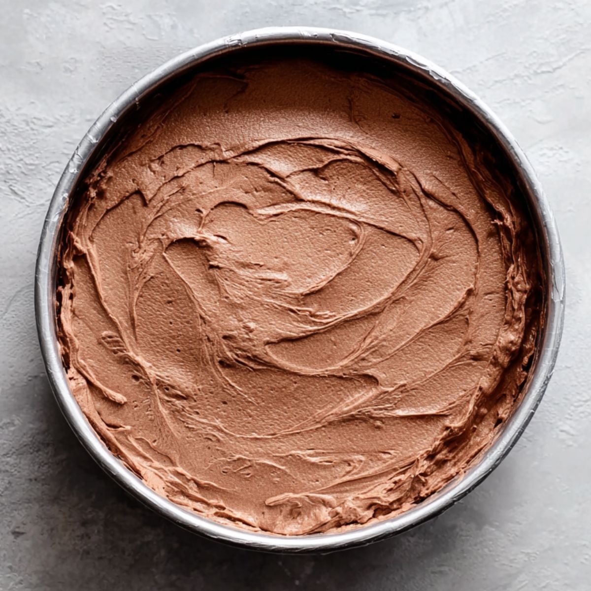 Best Ice Cream Cake Recipe 11 A rich, smooth layer of chocolate ice cream, spread evenly in the pan, with a whipped-cream-like texture.