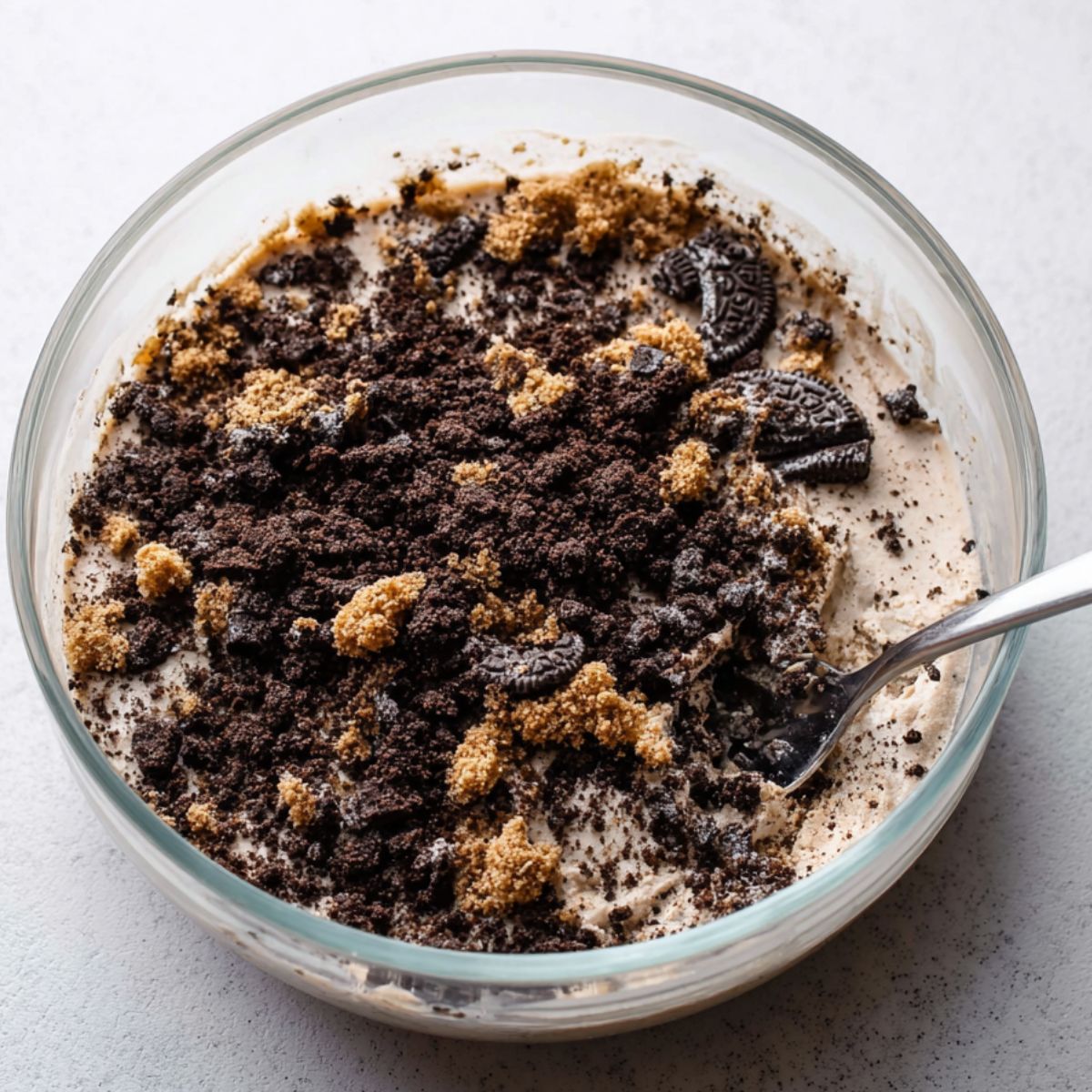 Best Ice Cream Cake Recipe 10 A mixture of Oreo crumbs and other crunchy elements for layering the ice cream cake. This adds a nice texture to the cake.