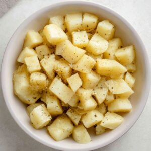 Easy Mediterranean Potato Salad Recipe 15 Salmon fillets grilling on a hot barbecue. The fish is slightly charred on the outside, with a perfect golden crust, while the inside remains tender and flaky, highlighting the delicate flavors of grilled seafood.