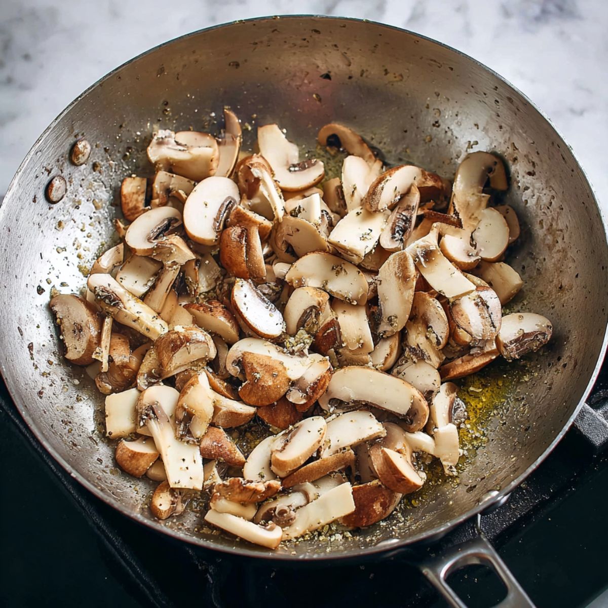Delicious Poutine Recipe 10 Fresh sliced mushrooms sautéing in a pan, ready to be added to a savory recipe.
