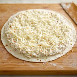 Easy Homemade Turkey Pinwheels Recipe 15 Sprinkling shredded cheese: "Top the cream cheese mixture with a generous amount of shredded mozzarella cheese to enhance the flavor and add richness."