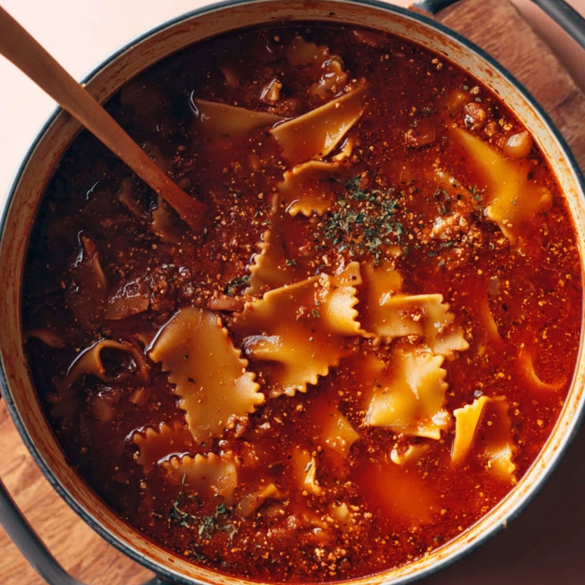 Delicious Vegan Lasagna Soup Recipe 13 A hearty vegan lasagna soup simmering in a large pot, with lasagna noodles and a rich tomato-based sauce.