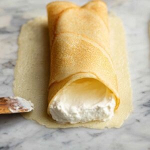 Healthy Homemade Blintzes Recipe 15 close-up showing the blintz wrapper being filled with a creamy or sweet filling, ready to be rolled.