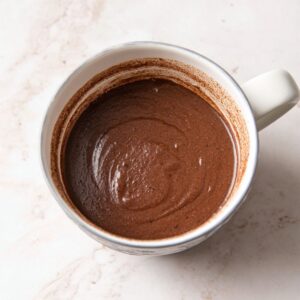 The Best Chocolate Mug Cake Recipe 15 A cup with smooth chocolate cake batter after mixing, ready for baking or microwaving.