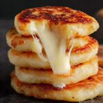 POTATO CHEESE PANCAKES Stack of crispy potato cheese pancakes with melted cheese stretching between them