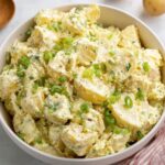 Southern Potato Salad Recipe A creamy and hearty potato salad with a sprinkling of fresh green onions, ready to serve as a side dish.