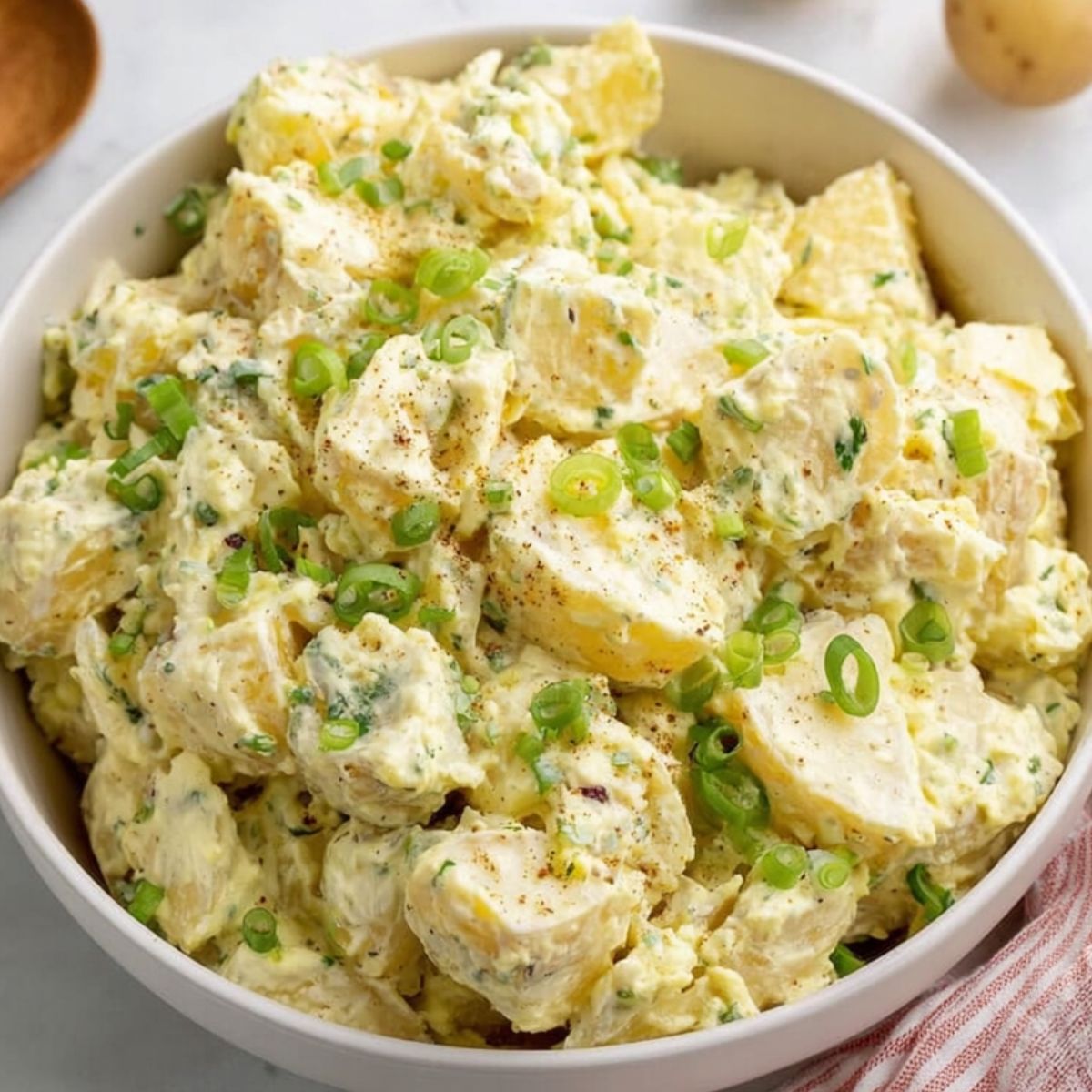 Southern Potato Salad Recipe A creamy and hearty potato salad with a sprinkling of fresh green onions, ready to serve as a side dish.