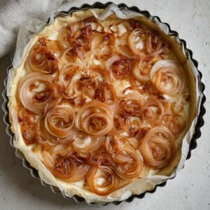 The Best Caramelized Onion Tart Recipe 15 Puff pastry pressed into a tart pan, edges crimped, ready to fill.