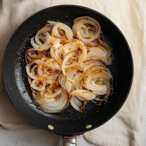 The Best Caramelized Onion Tart Recipe 14 Caramelized onions spread evenly over the tart pastry with a layer of creamy cheese underneath.