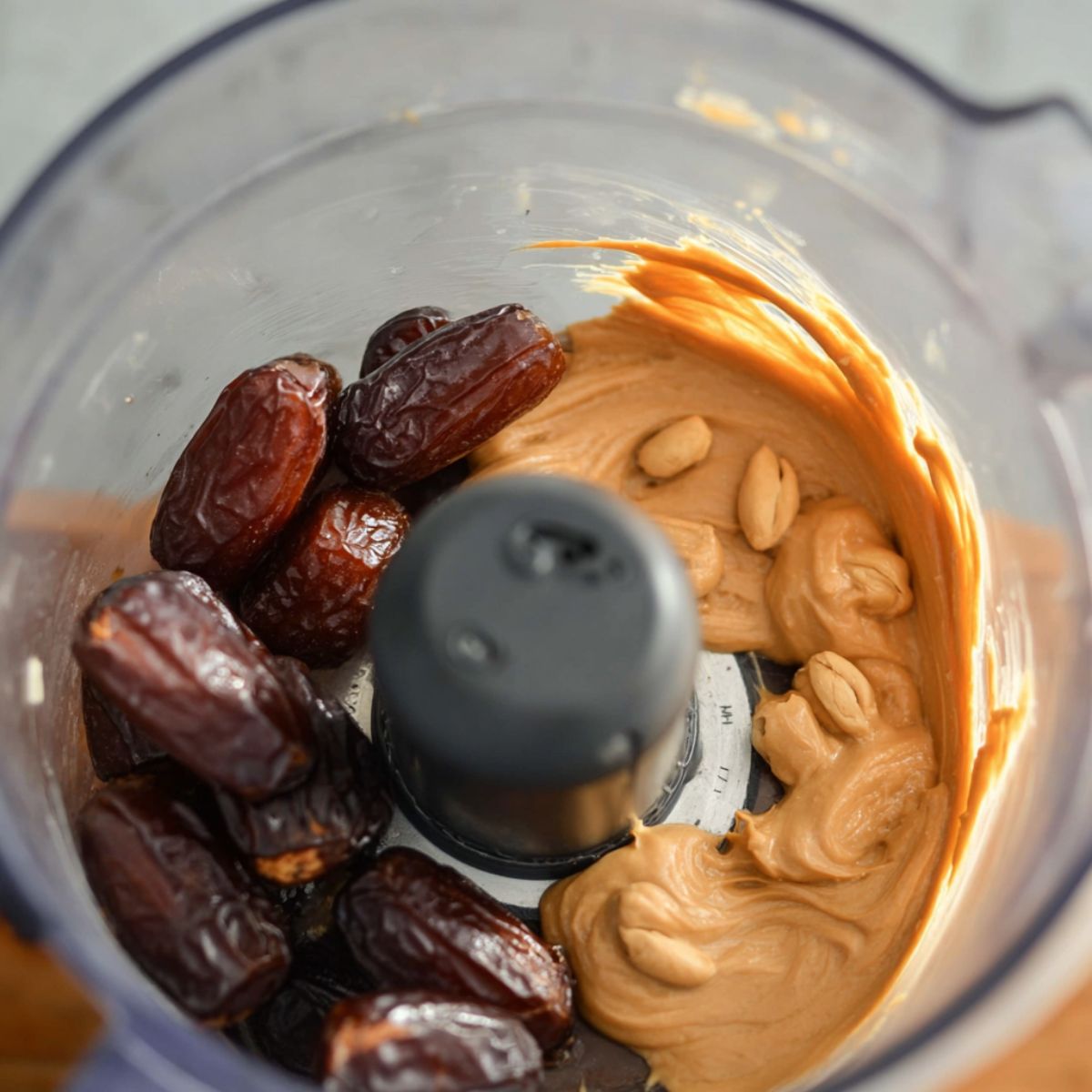The Best Date Brownies Recipe 11 Food processor with soaked dates and peanut butter being prepared to blend for brownie batter.