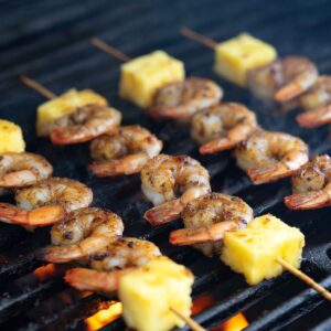 Easy Grilled Pineapple Shrimp Skewers 16 Shrimp and pineapple skewers cooking on a grill, showing the shrimp starting to char.